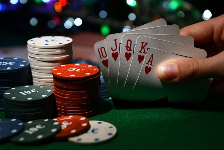 Live blackjack dealer at boss5000 studio with multi-deck shoe and player cards visible